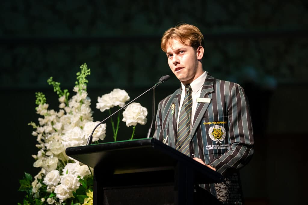 2025 Vice-Captain and Valedictorian Frederick Bromell is speaking at a podium during Valedictory dinner.