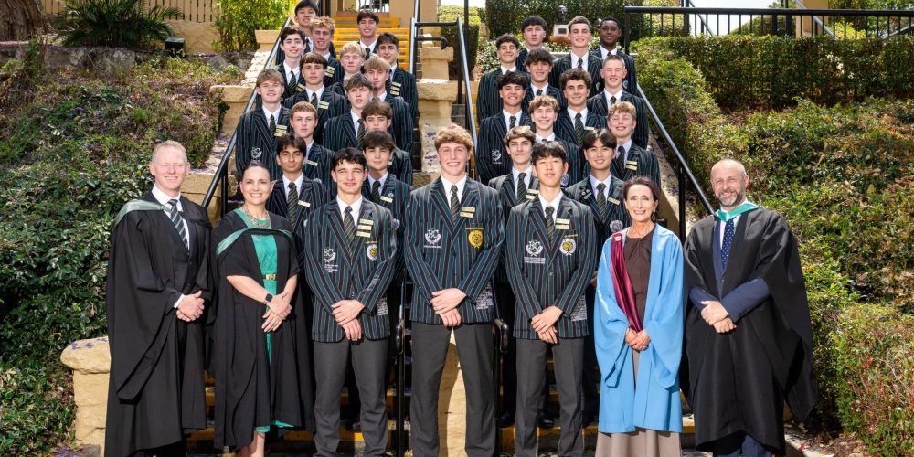 2026 Prefects and Senior Staff Members standing on entry steps after being inducted.