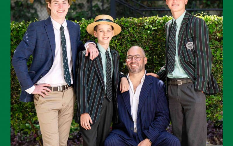 A family of four on the cover of the 2025 Summer Edition of Collegian Magazine. Three sons are standing and the father is seated. Two of the sons are in Brisbane Boys' College uniforms.